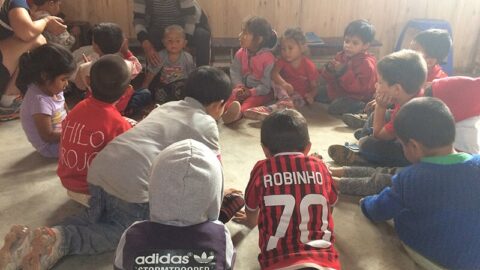 A group of children ina circle with their teacher