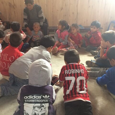 A group of children ina circle with their teacher