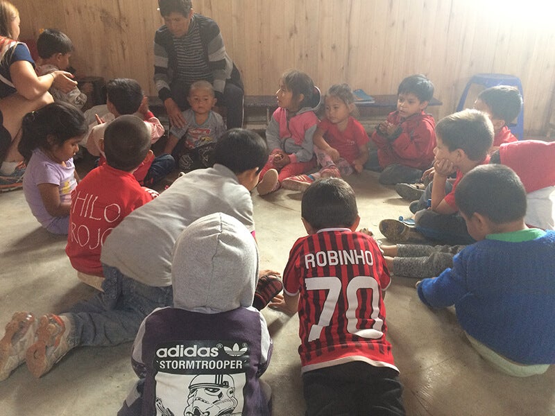 A group of children ina circle with their teacher