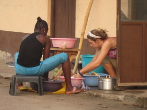 Washing Dishes in a village outside of Ho with Theresa, a friend and staff membet